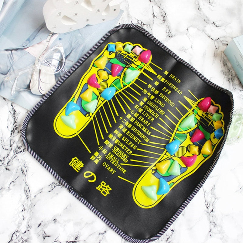 Colorful foot reflexology pad on a marble surface