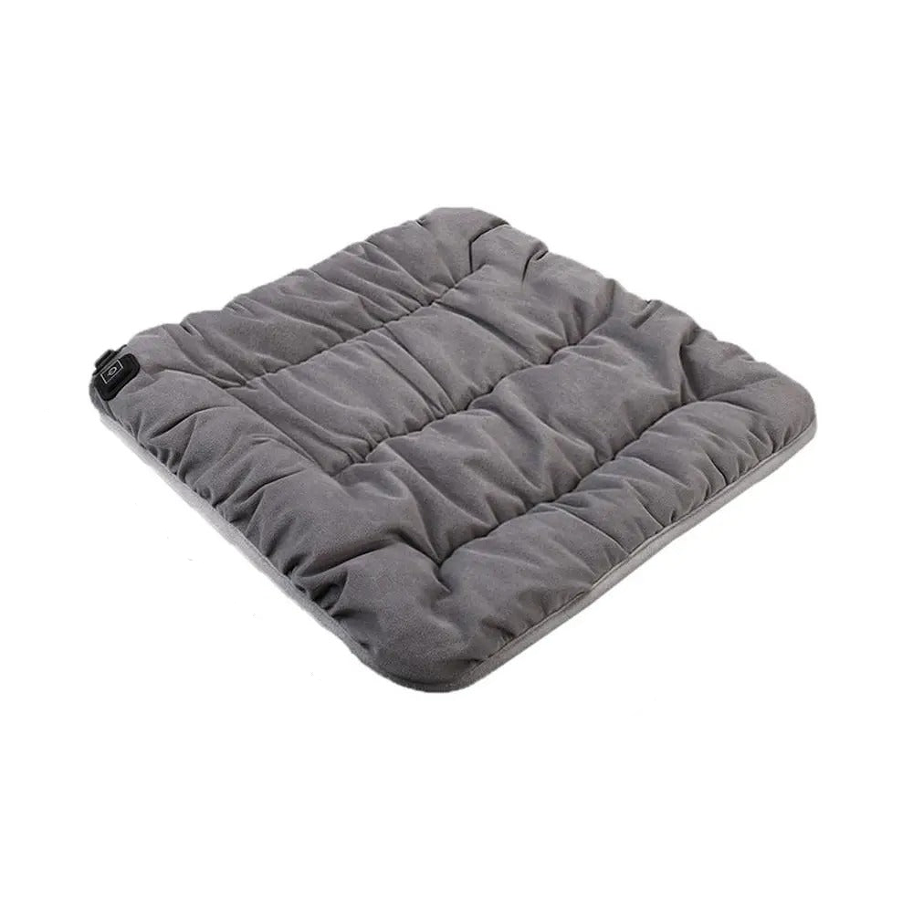 USB heated seat cushion in grey crystal velvet, front view on a chair, showing 45 x 45 cm size and simple one button control.